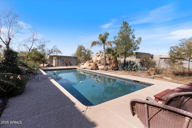 view of swimming pool with a patio area and a fenced in pool