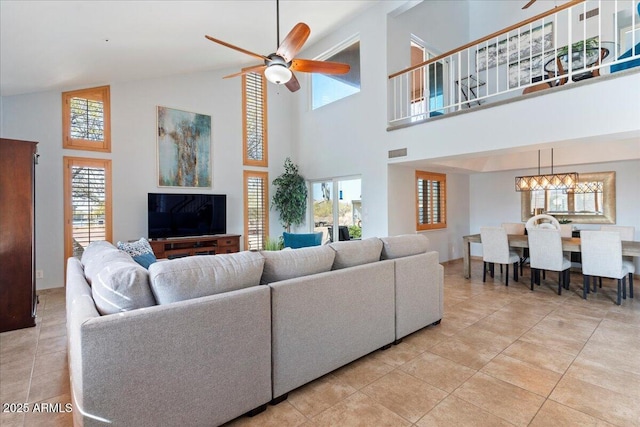 living room with light tile patterned floors, visible vents, and a ceiling fan