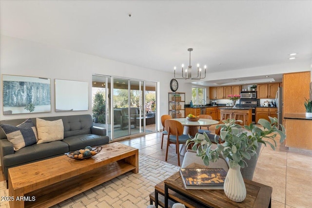 living room featuring light tile patterned floors and a notable chandelier