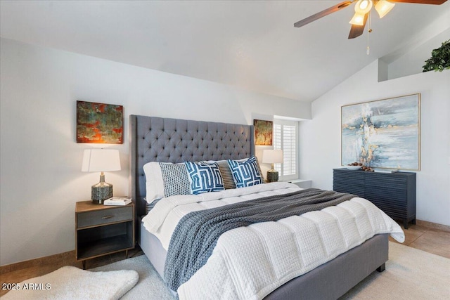 bedroom featuring lofted ceiling, light carpet, baseboards, and a ceiling fan