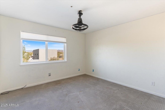 carpeted spare room with baseboards