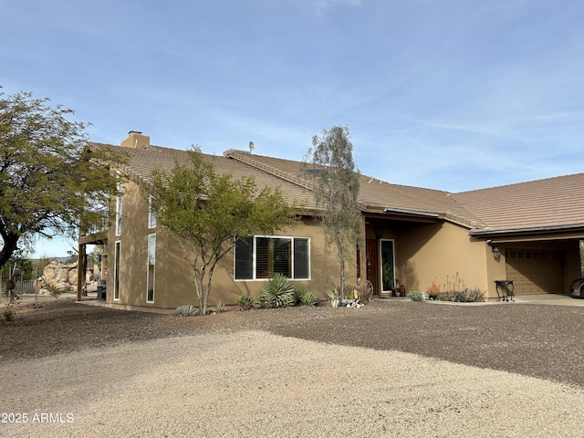 view of front of house featuring an attached garage and stucco siding