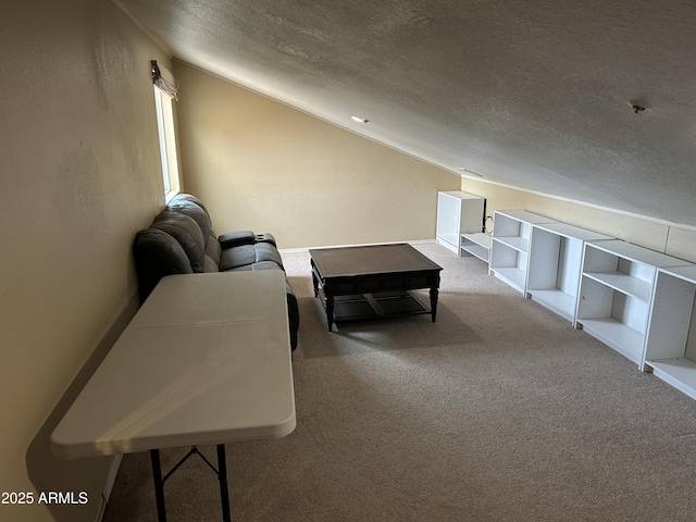 carpeted living room featuring built in shelves, vaulted ceiling, and a textured ceiling