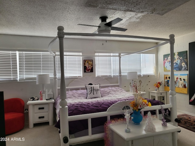 carpeted bedroom with a textured ceiling and ceiling fan