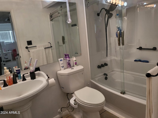 full bathroom with toilet, enclosed tub / shower combo, and sink