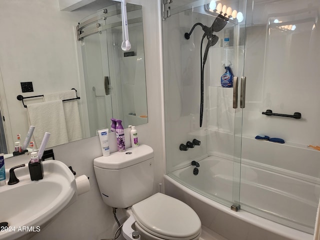 full bathroom with enclosed tub / shower combo, toilet, and sink