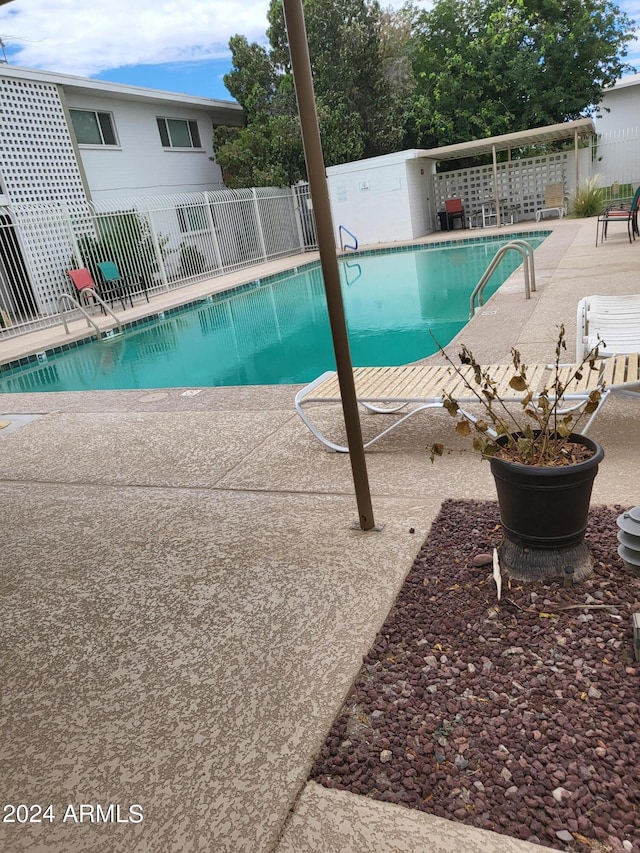 view of swimming pool with a patio area