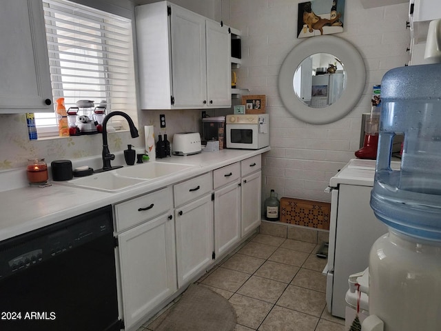 kitchen with sink, white cabinets, light tile patterned floors, and black dishwasher