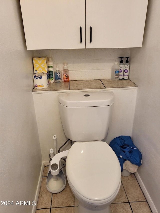 bathroom with tile patterned floors and toilet