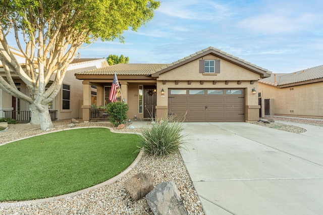 7027 W Blackhawk Dr, Glendale, AZ 85308 - view of front of house with a garage, driveway, stucco siding, a tiled roof, and a front yard