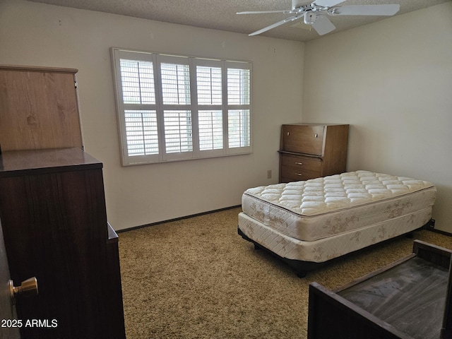 bedroom featuring ceiling fan, a textured ceiling, and baseboards