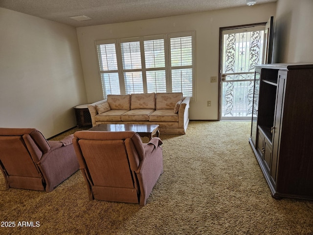 living room featuring a textured ceiling, baseboards, and light colored carpet