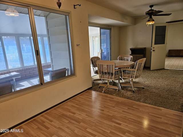 dining room with ceiling fan, baseboards, and wood finished floors