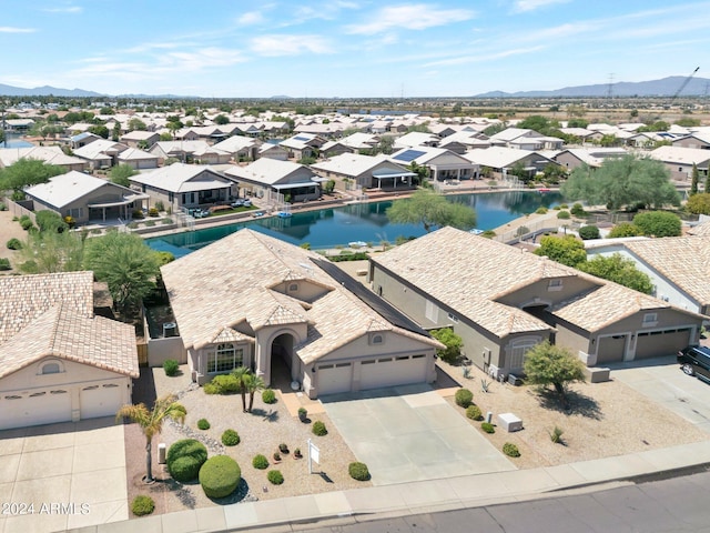 drone / aerial view featuring a water and mountain view