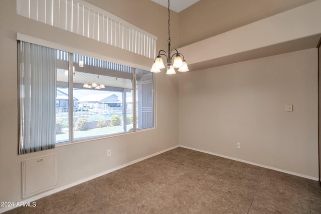 empty room featuring an inviting chandelier