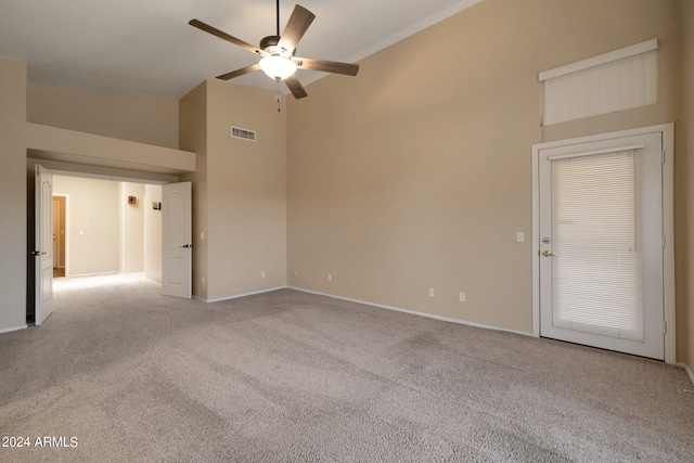 carpeted spare room with high vaulted ceiling and ceiling fan