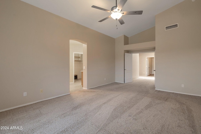 unfurnished room featuring ceiling fan, light colored carpet, and lofted ceiling