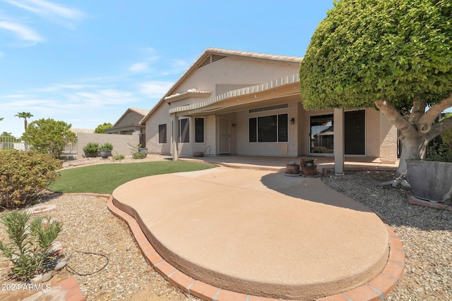 back of house with a patio