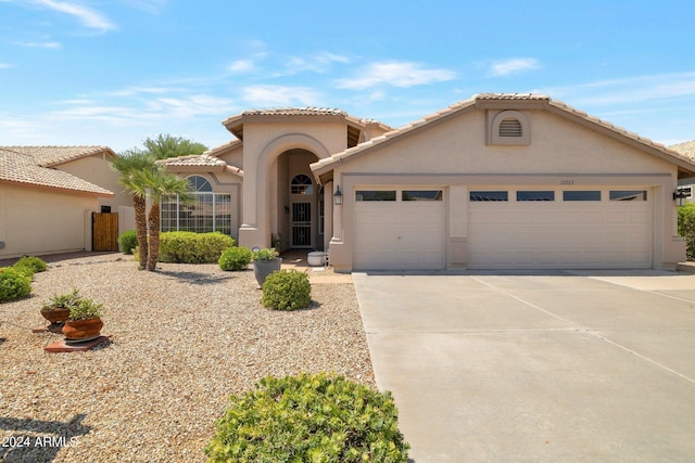 mediterranean / spanish-style house featuring a garage