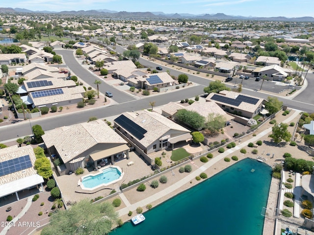 drone / aerial view featuring a water and mountain view