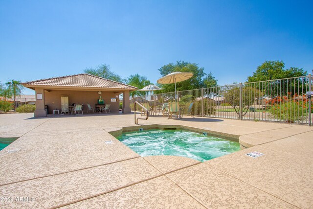 view of pool with a community hot tub and a patio