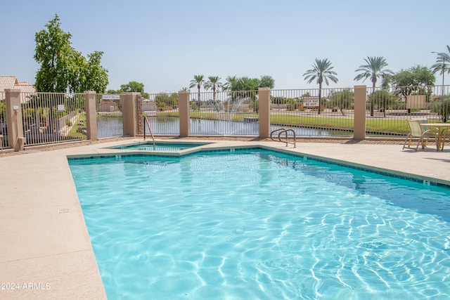 view of pool featuring a water view