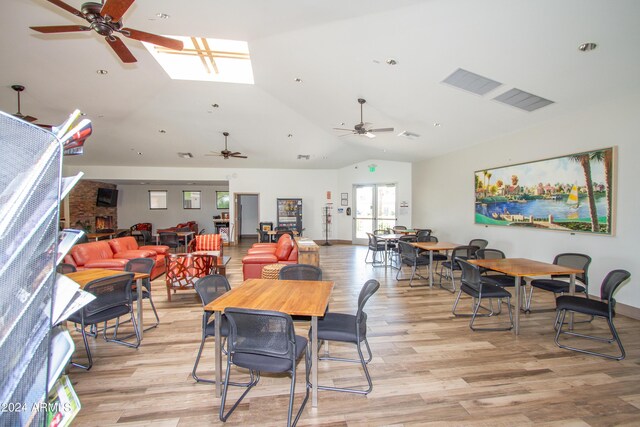 dining space featuring vaulted ceiling, ceiling fan, and light hardwood / wood-style floors