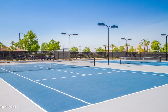 view of tennis court featuring basketball hoop