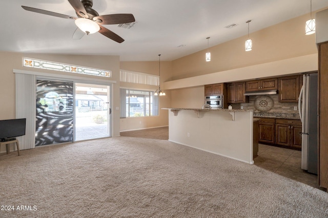 unfurnished living room with high vaulted ceiling, light colored carpet, and ceiling fan with notable chandelier