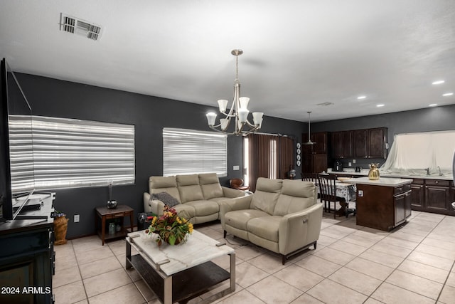 living room featuring light tile patterned flooring and a chandelier