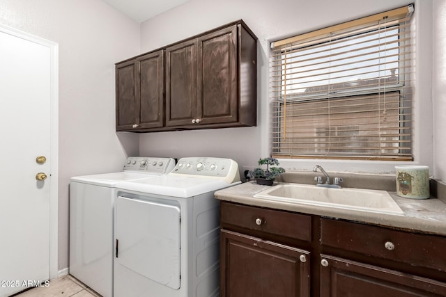 laundry area with a sink, cabinet space, and washer and dryer