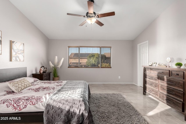 bedroom featuring lofted ceiling, baseboards, and a ceiling fan