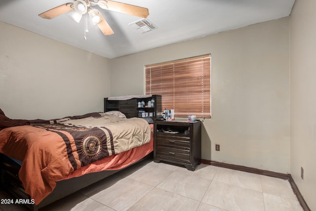 tiled bedroom featuring ceiling fan