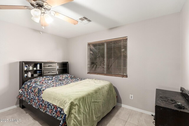 tiled bedroom featuring ceiling fan