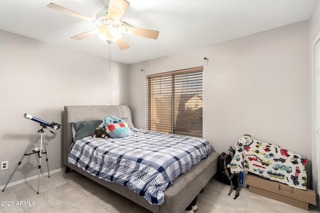 bedroom featuring a ceiling fan, baseboards, and light tile patterned floors