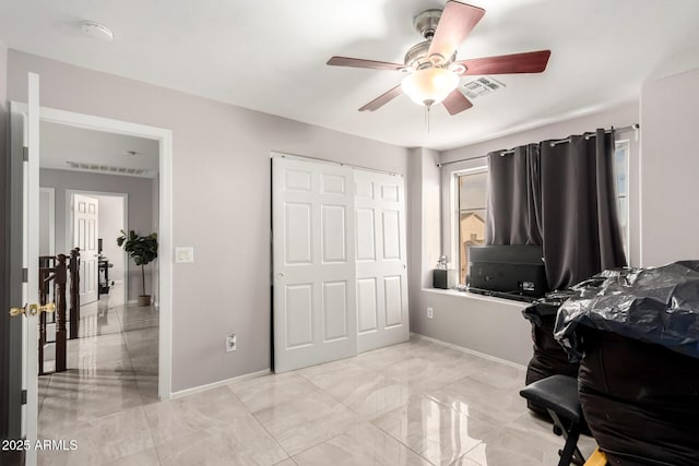 bedroom featuring marble finish floor, baseboards, visible vents, and a closet