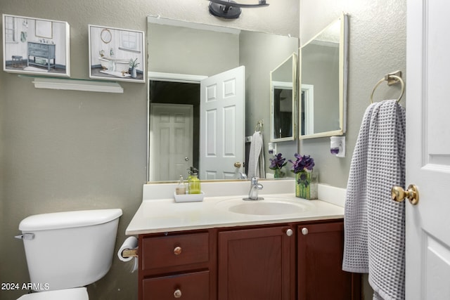 bathroom featuring toilet and vanity