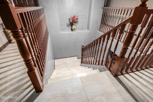 stairs featuring tile patterned floors