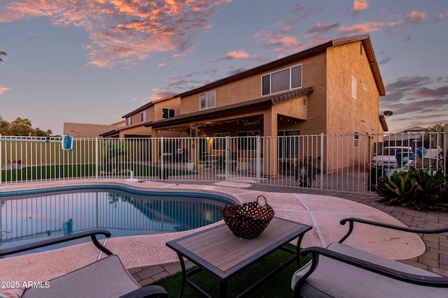 view of swimming pool featuring fence, a fenced in pool, and a patio