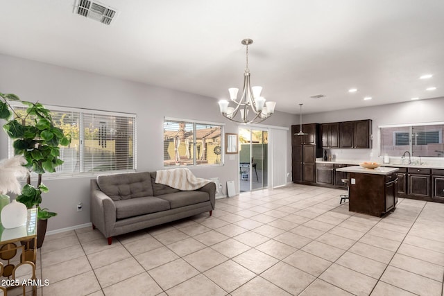 living room with recessed lighting, light tile patterned flooring, visible vents, and an inviting chandelier