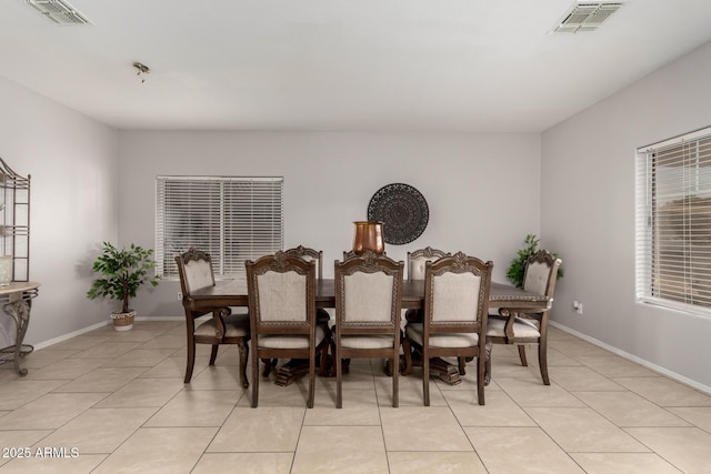 dining room with light tile patterned floors, baseboards, and visible vents