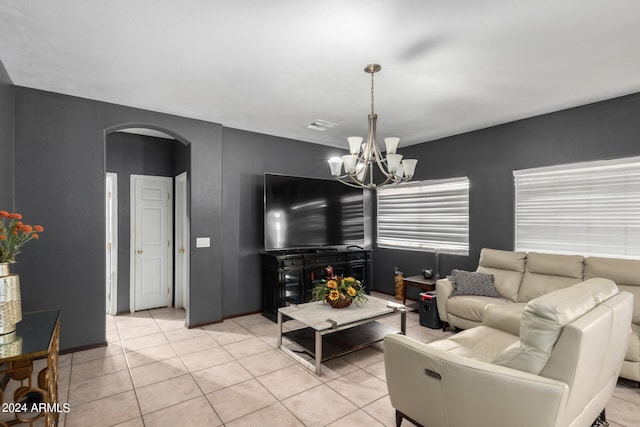 living room featuring a chandelier and light tile patterned floors