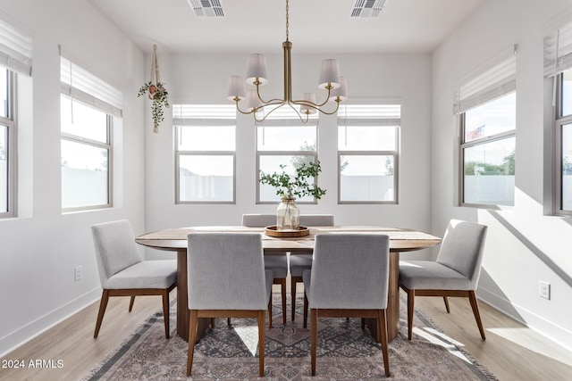 35612 N Lodestone Dr, San Tan Valley, AZ 85144 - dining area with a chandelier, light wood finished floors, and baseboards