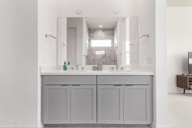 35612 N Lodestone Dr, San Tan Valley, AZ 85144 - bathroom featuring a marble finish shower, double vanity, and baseboards