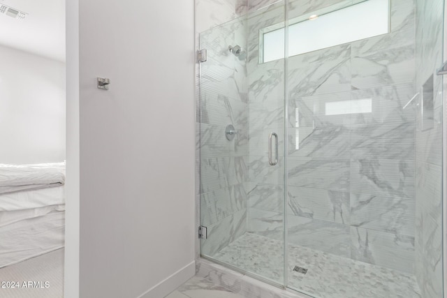 35612 N Lodestone Dr, San Tan Valley, AZ 85144 - bathroom with marble look tile flooring, a shower stall, and baseboards
