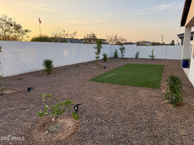 35612 N Lodestone Dr, San Tan Valley, AZ 85144 - yard at dusk featuring a fenced backyard