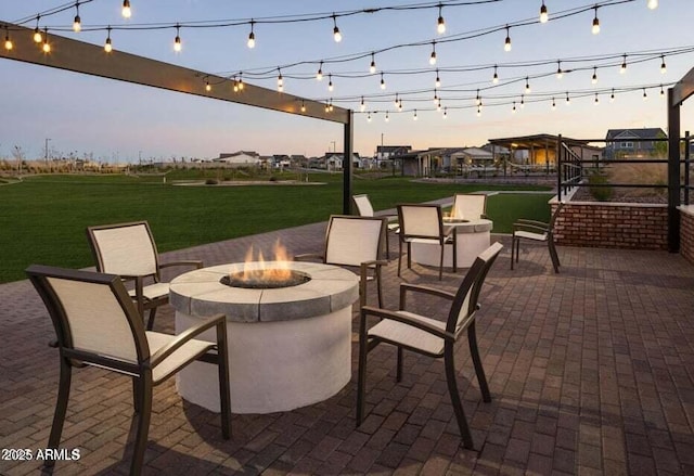 35612 N Lodestone Dr, San Tan Valley, AZ 85144 - patio terrace at dusk with an outdoor fire pit, a patio, and a yard