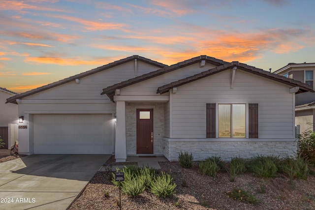 35612 N Lodestone Dr, San Tan Valley, AZ 85144 - view of front facade featuring an attached garage, concrete driveway, and stone siding