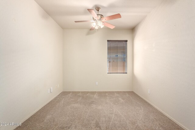 carpeted empty room featuring ceiling fan