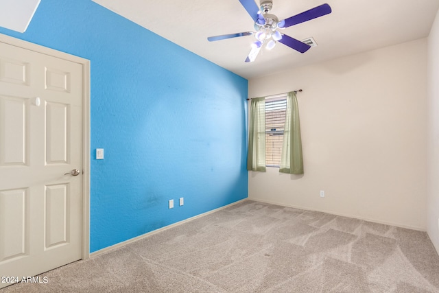 unfurnished room featuring light carpet and ceiling fan